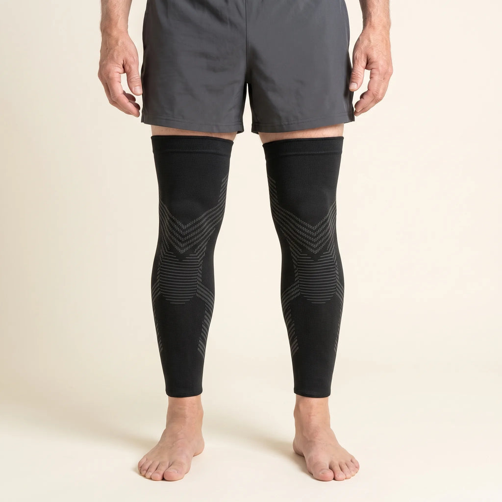 Man wearing a pair of TORVELL full-leg knee compression sleeves