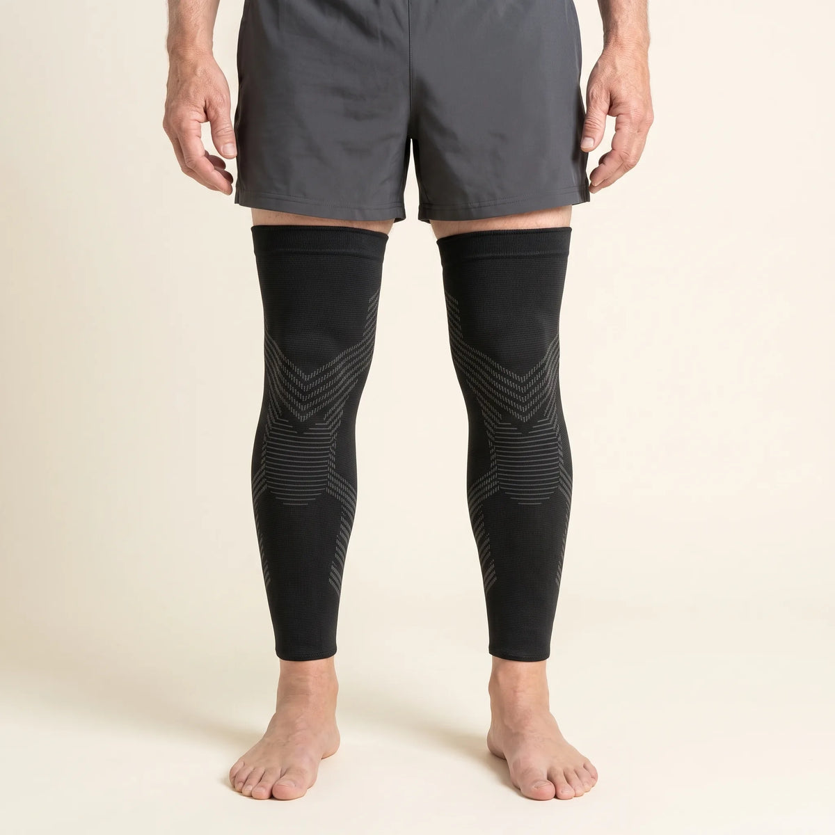 Man wearing a pair of TORVELL full-leg knee compression sleeves
